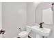 Cozy powder room features a pedestal sink, and modern fixtures at 10029 Cluny Ave, Las Vegas, NV 89178