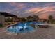 Backyard pool with spa and in-pool loungers under a beautiful sunset at 10084 Terrastone Dr, Las Vegas, NV 89148