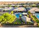 A private backyard paradise featuring a swimming pool, spa, putting green, and lush landscaping at 10084 Terrastone Dr, Las Vegas, NV 89148