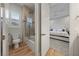 Modern bathroom features a shower-over-tub and a view into the bedroom with carpeted floor and ceiling fan at 10084 Terrastone Dr, Las Vegas, NV 89148