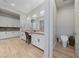 Bright bathroom featuring double vanity, granite countertop, white cabinets, and dedicated toilet area at 10084 Terrastone Dr, Las Vegas, NV 89148