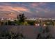 Breathtaking city view at dusk with mountain backdrop, as seen from a beautiful residence at 10084 Terrastone Dr, Las Vegas, NV 89148