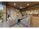 Relaxing covered outdoor living area with fireplace, ceiling fan and view into the home at 10084 Terrastone Dr, Las Vegas, NV 89148