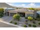 Stunning single-story home featuring a stone facade, solar panels, three-car garage, and professionally landscaped front yard at 10084 Terrastone Dr, Las Vegas, NV 89148