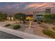 Contemporary home featuring stone accents, desert landscaping, and a welcoming entrance with lighted steps at 10084 Terrastone Dr, Las Vegas, NV 89148