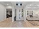 Inviting entryway showcasing herringbone wood floors and access to the home theater and living room at 10084 Terrastone Dr, Las Vegas, NV 89148
