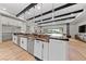 Spacious kitchen features a large island with granite countertops, stainless steel appliances, and custom lighting fixtures at 10084 Terrastone Dr, Las Vegas, NV 89148