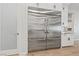 Stainless steel refrigerator with white surrounding cabinets and light hardwood floors at 10084 Terrastone Dr, Las Vegas, NV 89148
