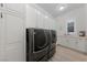 Laundry room with modern washer and dryer, storage cabinets, and ample counter space at 10084 Terrastone Dr, Las Vegas, NV 89148