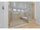 Luxurious bathroom features a glass-enclosed shower with multiple shower heads and a separate soaking tub at 10084 Terrastone Dr, Las Vegas, NV 89148