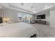 Bright main bedroom with a tray ceiling, large windows, and modern furnishings at 10084 Terrastone Dr, Las Vegas, NV 89148