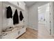 Mud room with bench and storage leading to laundry area at 10084 Terrastone Dr, Las Vegas, NV 89148