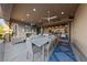 Spacious outdoor patio with fireplace, dining area, and bar overlooking backyard at 10084 Terrastone Dr, Las Vegas, NV 89148