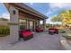Relaxing outdoor patio with comfortable seating, mature landscaping, and manicured backyard at 10084 Terrastone Dr, Las Vegas, NV 89148