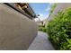 Private outdoor shower area with stone pathway and lush landscaping at 10084 Terrastone Dr, Las Vegas, NV 89148