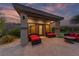 Covered patio featuring comfortable seating, offering a serene outdoor living space with lush landscaping at 10084 Terrastone Dr, Las Vegas, NV 89148