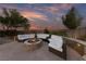 Inviting outdoor patio featuring a stone fire pit and comfortable seating, perfect for relaxing evenings at 10084 Terrastone Dr, Las Vegas, NV 89148