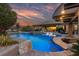 Spectacular pool featuring a swim-up bar and built-in seating, ideal for entertaining and relaxation at 10084 Terrastone Dr, Las Vegas, NV 89148