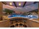 Fantastic pool area featuring a swim-up bar, waterfall, and lounge chairs with desert landscaping at 10084 Terrastone Dr, Las Vegas, NV 89148