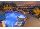 Resort-style pool boasts a rock waterfall, jacuzzi, tanning ledge, and fire pit seating area, with city views at 10084 Terrastone Dr, Las Vegas, NV 89148