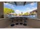 Covered swim-up bar with stools overlooking the outdoor pool and lush landscaping at 10084 Terrastone Dr, Las Vegas, NV 89148