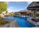 Stunning pool area with lounge seating, jacuzzi, water features, and swim-up bar at 10084 Terrastone Dr, Las Vegas, NV 89148