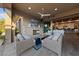 Relaxing covered outdoor living area with fireplace, ceiling fan and view into the home at 10084 Terrastone Dr, Las Vegas, NV 89148