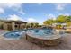 Backyard pool features in-pool loungers, waterfall feature, and spa at 10084 Terrastone Dr, Las Vegas, NV 89148