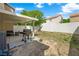 A spacious backyard featuring a patio, grill, and a block wall fence offering privacy at 10244 Amber Hue Ln, Las Vegas, NV 89144