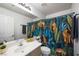 Charming bathroom with vibrant shower curtain and vanity with large mirror and stylish accents at 10244 Amber Hue Ln, Las Vegas, NV 89144