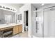 Bright bathroom with double vanity, wood look floors and glass enclosed shower at 10244 Amber Hue Ln, Las Vegas, NV 89144