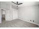 Neutral bedroom with ceiling fan, closet and access to the hallway at 10244 Amber Hue Ln, Las Vegas, NV 89144