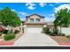 Charming two-story townhouse featuring a two-car garage, well-maintained landscaping and a concrete driveway at 10244 Amber Hue Ln, Las Vegas, NV 89144