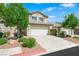 Charming two-story townhouse with desert landscaping, a two-car garage and concrete driveway at 10244 Amber Hue Ln, Las Vegas, NV 89144