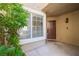 Inviting front porch featuring a brown door, a 'hello' doormat, and adjacent window at 10244 Amber Hue Ln, Las Vegas, NV 89144