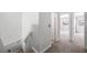 Second floor hallway leading to rooms featuring carpet flooring and natural light at 10244 Amber Hue Ln, Las Vegas, NV 89144
