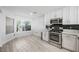 Renovated kitchen featuring stainless appliances, modern backsplash and ample cabinet space at 10244 Amber Hue Ln, Las Vegas, NV 89144