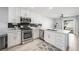 Updated kitchen with stainless steel appliances, white cabinetry, and modern countertops at 10244 Amber Hue Ln, Las Vegas, NV 89144