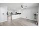 Bright kitchen features white cabinets, stainless steel appliances, tile backsplash, and wood-look floors at 10244 Amber Hue Ln, Las Vegas, NV 89144