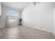 Bright living room with hardwood flooring, a large arched window and bright lighting at 10244 Amber Hue Ln, Las Vegas, NV 89144