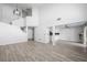 Bright living room with high ceilings, hardwood flooring, and an open floor plan to the kitchen at 10244 Amber Hue Ln, Las Vegas, NV 89144