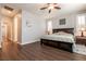 Spacious bedroom featuring wood floors, ceiling fan, and natural light at 10417 Artful Stone Ave, Las Vegas, NV 89149