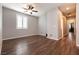 Spacious bedroom boasting wood floors, natural light, and neutral walls at 10417 Artful Stone Ave, Las Vegas, NV 89149
