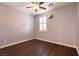 Bedroom with wood floors, a window, ceiling fan and neutral walls at 10417 Artful Stone Ave, Las Vegas, NV 89149