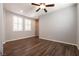Wood floors enhance a bright and airy bedroom with natural lighting at 10417 Artful Stone Ave, Las Vegas, NV 89149