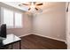 Well-lit bedroom featuring hardwood floors and a ceiling fan at 10417 Artful Stone Ave, Las Vegas, NV 89149