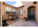 Inviting courtyard featuring a cozy swing, planters, and an attractive front door at 10417 Artful Stone Ave, Las Vegas, NV 89149