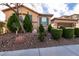 Charming single-story home featuring a well-maintained front yard with mature landscaping at 10417 Artful Stone Ave, Las Vegas, NV 89149