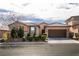 Charming single-story home featuring a two-car garage, desert landscaping, and a welcoming facade in a suburban neighborhood at 10417 Artful Stone Ave, Las Vegas, NV 89149
