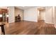 Spacious living room featuring wood-look floors and a seamless connection to the kitchen at 10417 Artful Stone Ave, Las Vegas, NV 89149